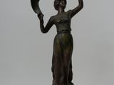 bronze statue of a woman holding a fan on a marble base
