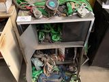 a pile of junk on the ground next to a yellow wall