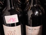 several bottles of wine are lined up on a shelf