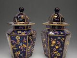 pair of blue and gold vases with floral designs on them