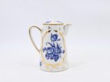 a small blue and white pitcher with a gold rim