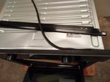 a metal tray with a black handle on top of it