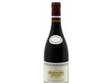 the bottle of wine is sitting on a white surface