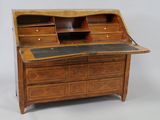 a wooden desk with a marble top and drawers