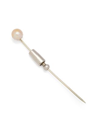 a close up of a metal needle with a pearl on it