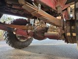 a close up view of a truck ' s axle and wheel