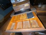 an old wooden box with many compartments on it