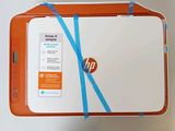 a white and orange hp laptop with a blue ribbon around it