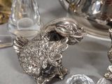 a silver tea pot and a silver tea set on a table