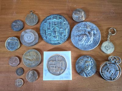 some coins and other coins on a table with a piece of paper