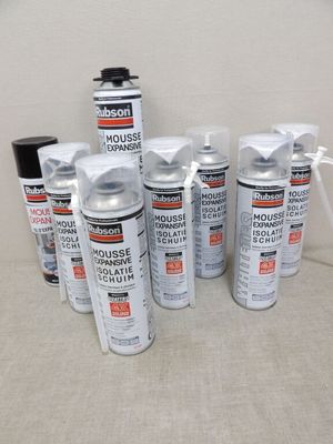 several cans of mousse sprays are lined up on a table