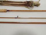 several different types of fishing rods are lined up on a table