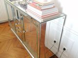a glass table with books and a lamp on it