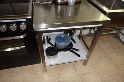 a small kitchen with a stove, sink, and stove top