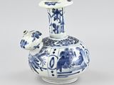 a blue and white vase with a bird on it