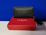 a black and red wallet sitting on top of a red box