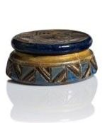a small blue and gold box on a white surface