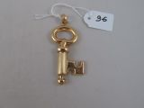 a close up of a gold key with a tag on it