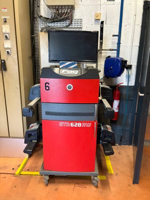 an image of a red and black machine in a garage