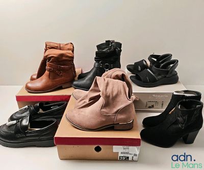 several pairs of women ' s shoes sitting on top of boxes on a table