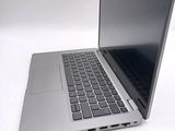 a silver laptop with a black keyboard on a white surface