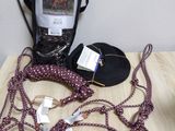 a table with a cell phone, a cell phone, and other items on it