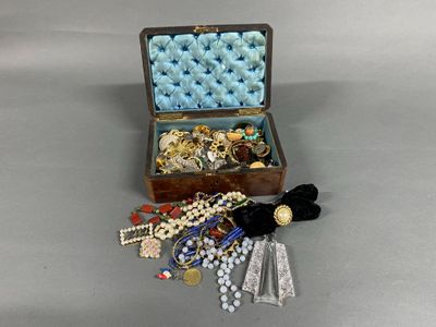 a small wooden box filled with jewelry on a table