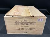 a wooden box with a bottle of wine inside of it