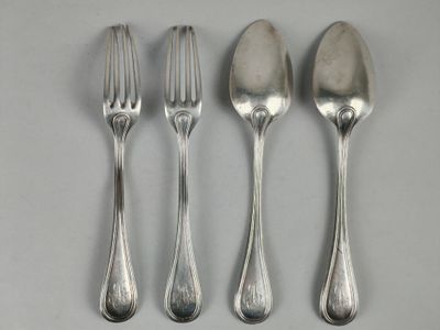 three silver spoons and a fork on a white surface