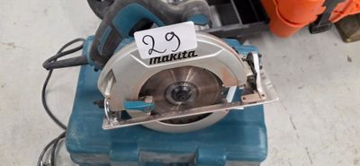 someone is using a circular saw to cut a piece of wood