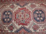 an oriental rug with a red, blue, and green design