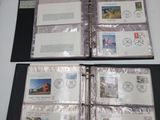 two pages of a binder with stamps on them sitting on a table