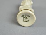 a small white vase with a dog on it