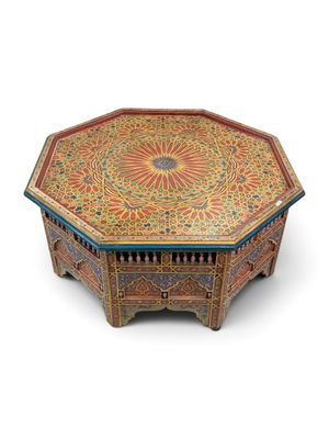 a close up of a wooden table with a colorful design on it