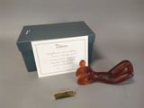 a small red dog figurine next to a box