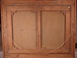 an old wooden frame with a painting hanging on a wall
