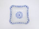 a close up of a blue and white plate on a white surface