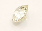 a close up of a white diamond on a white surface