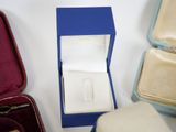 a box with a ring inside of it sitting on a table