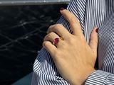 someone is holding a ring on their left hand and a ring on their right hand
