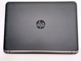 the hp laptop is sitting on a white surface with a logo on it