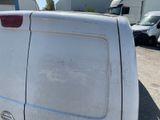 a white van parked in a parking lot with other vehicles