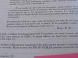 a pink piece of paper on top of an open book