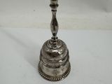 a silver plated candle holder on a white surface