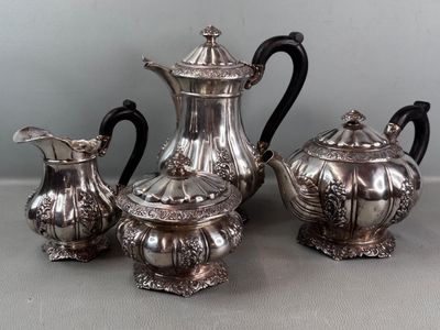 three silver teapots sitting on a table next to each other