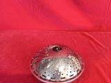 an old silver plate with a lid on a red cloth