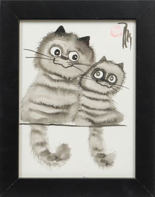 une photo de deux chats assis l'un à côté de l'autre