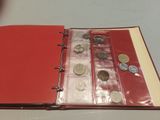 a red binder with coins in it on a table