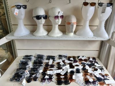several mannequin heads and sunglasses are on display in a store