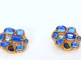 two pairs of blue and goldtone earrings on a white surface